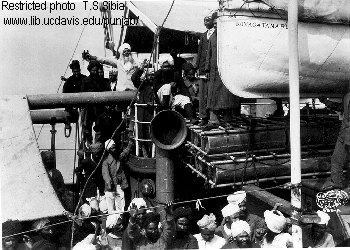 1914. Sikhs aboard the Komagata Maru . Gurdit Singh is wearing the light-colored suit, white beard, at the time of the Komagata Maru incident.